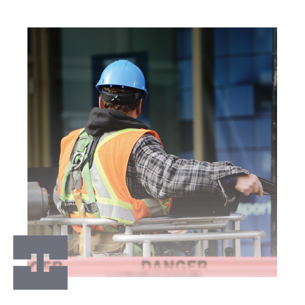 Construction worker wearing safety gear on site.